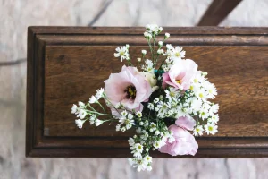 casket with flowers placed on top at a funeral